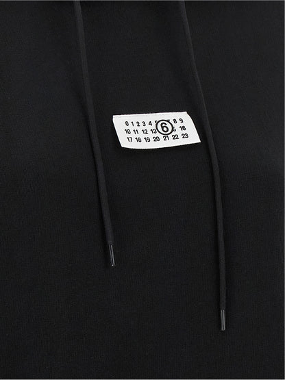 Sweatshirt Hoodie by MM6 Maison Margiela for women in cotton black, white & signature features an avant-garde silhouette, showcasing a sophisticated and detail for a truly avant-garde finish.