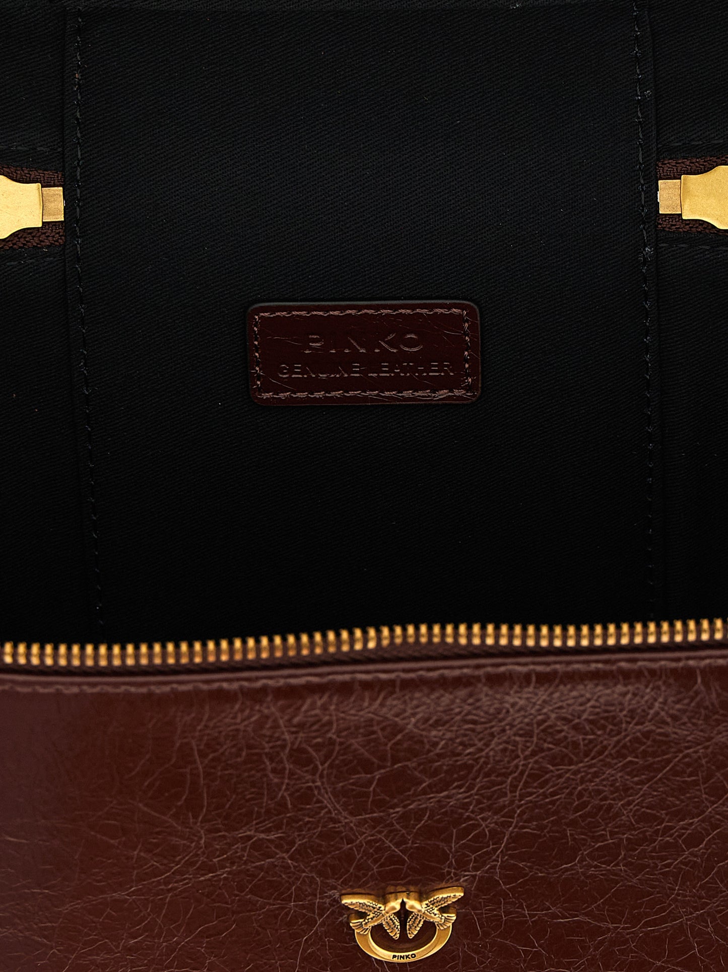 Vanity Handbag by PINKO for women in calfskin leather brown & gold features a ornamental silhouette, showcasing a secure zipper, ample , and ornamental shoulder-strap, handle & adjustable-strap for a sophisticated look.