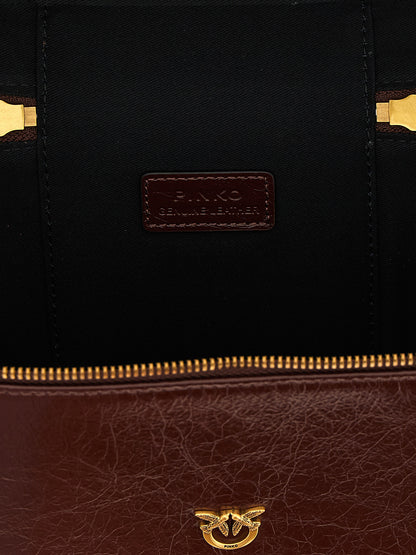 Vanity Handbag by PINKO for women in calfskin leather brown & gold features a ornamental silhouette, showcasing a secure zipper, ample , and ornamental shoulder-strap, handle & adjustable-strap for a sophisticated look.