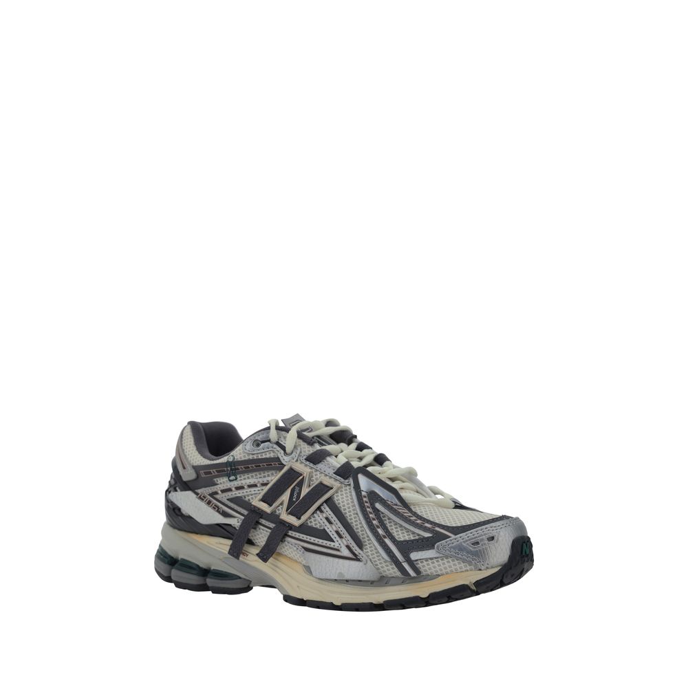 Athletic Sneakers by New Balance for men in fabric mesh silver & monogram features an effortless chic silhouette, showcasing the signature athletic style of the Men's Athletic Fabric Mesh Sneakers collection with a truly effortless chic finish.