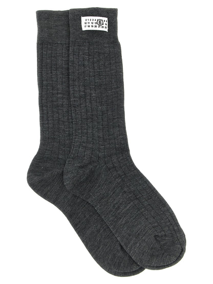 These Socks by MM6 Maison Margiela for women in polyamide calf leather & wool gray, white & signature present a utilitarian silhouette from the Women's Polyamide Calf Leather & Wool Socks collection, offering a utilitarian fit and refined aesthetic.