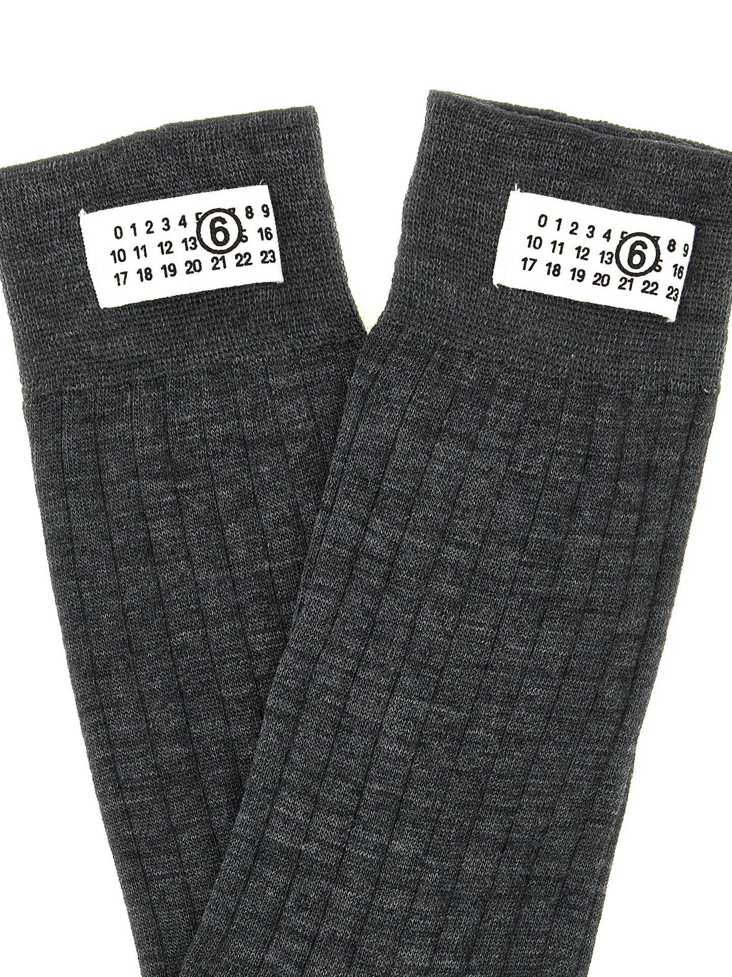Socks by MM6 Maison Margiela for women in polyamide calf leather & wool gray, white & signature features an utilitarian chic finish from the Women's Polyamide Calf Leather & Wool Socks collection, offering an utilitarian chic fit that ensures sophisticated comfort.