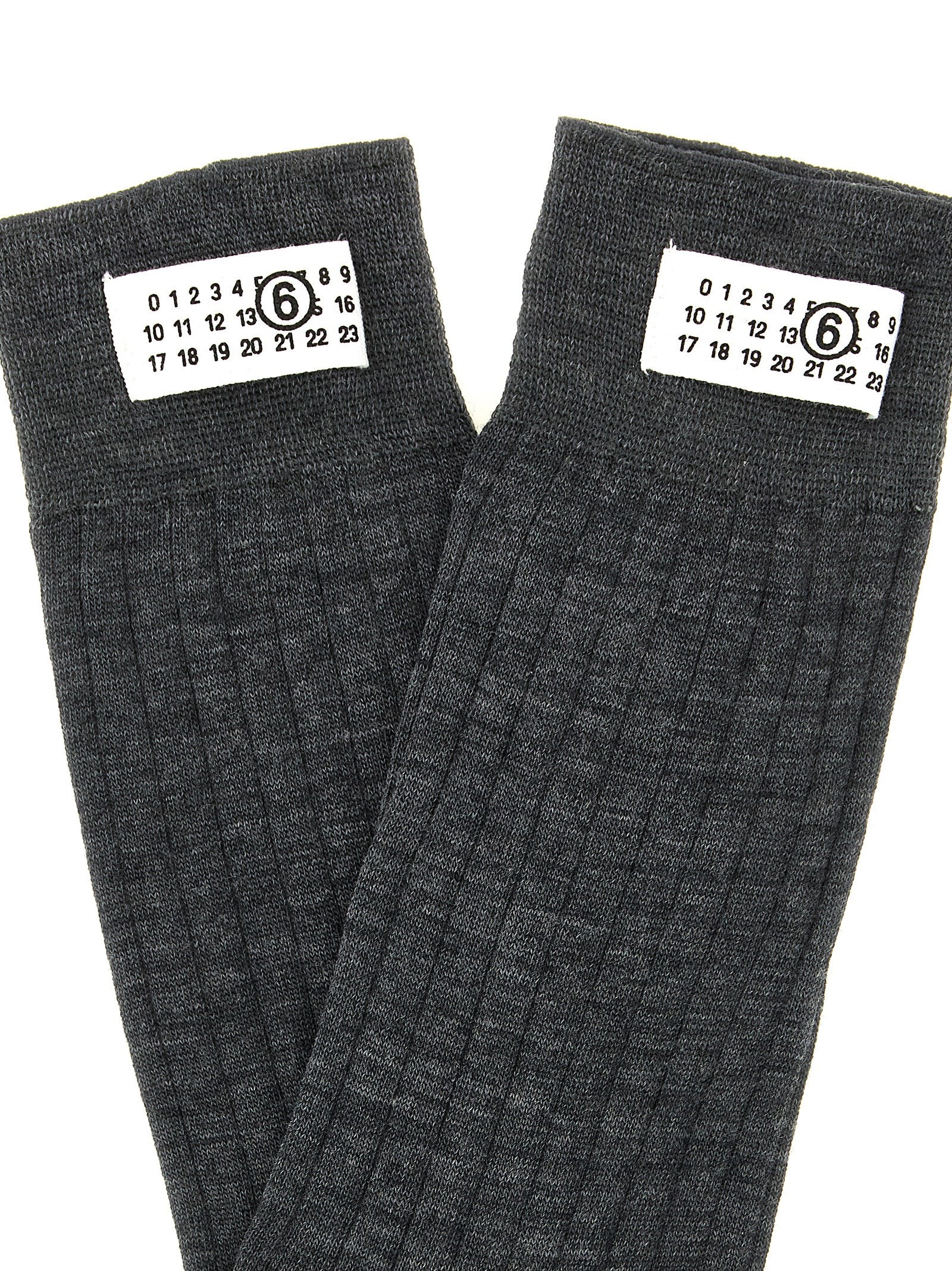 Socks by MM6 Maison Margiela for women in polyamide calf leather & wool gray, white & signature features an utilitarian chic finish from the Women's Polyamide Calf Leather & Wool Socks collection, offering an utilitarian chic fit that ensures sophisticated comfort.