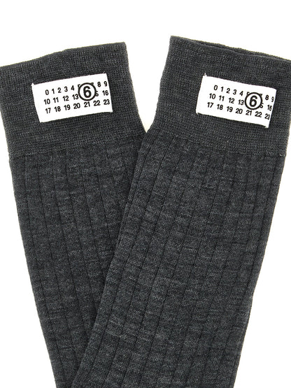 Socks by MM6 Maison Margiela for women in polyamide calf leather & wool gray, white & signature features an utilitarian chic finish from the Women's Polyamide Calf Leather & Wool Socks collection, offering an utilitarian chic fit that ensures sophisticated comfort.