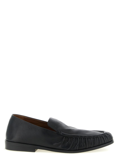 Flat Moccasin Moccasins Loafer Slip-On Shoes by Marsell for men in calfskin leather black & natural features an dynamic silhouette from the Men's Calfskin Leather Flat Moccasin Moccasins Loafer Slip-On Shoes collection, defined by a dynamic and flat for a dynamic look.