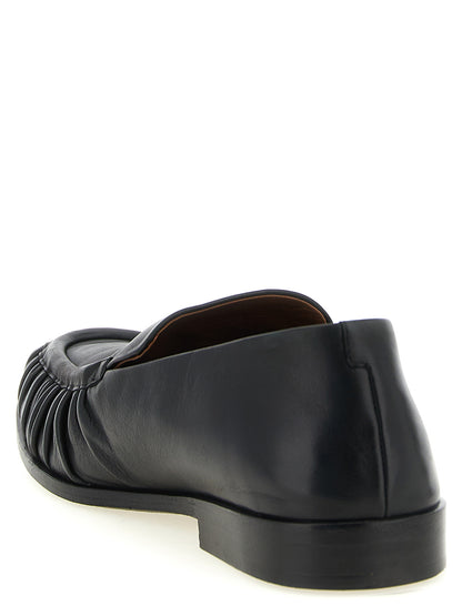 Flat Moccasin Moccasins Loafer Slip-On Shoes by Marsell for men in calfskin leather black & natural showcases a timeless silhouette from the Men's Calfskin Leather Flat Moccasin Moccasins Loafer Slip-On Shoes collection, featuring a timeless flat and for a timeless finish.