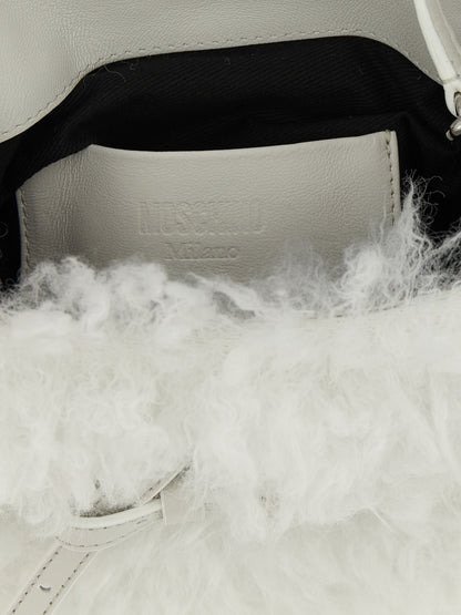 Small Handbag by Moschino for women in leather & velvet silver & white features a ornamental silhouette, showcasing a secure buckle, ample , and ornamental shoulder-strap, handle, adjustable-strap & belt-strap for a sophisticated look.