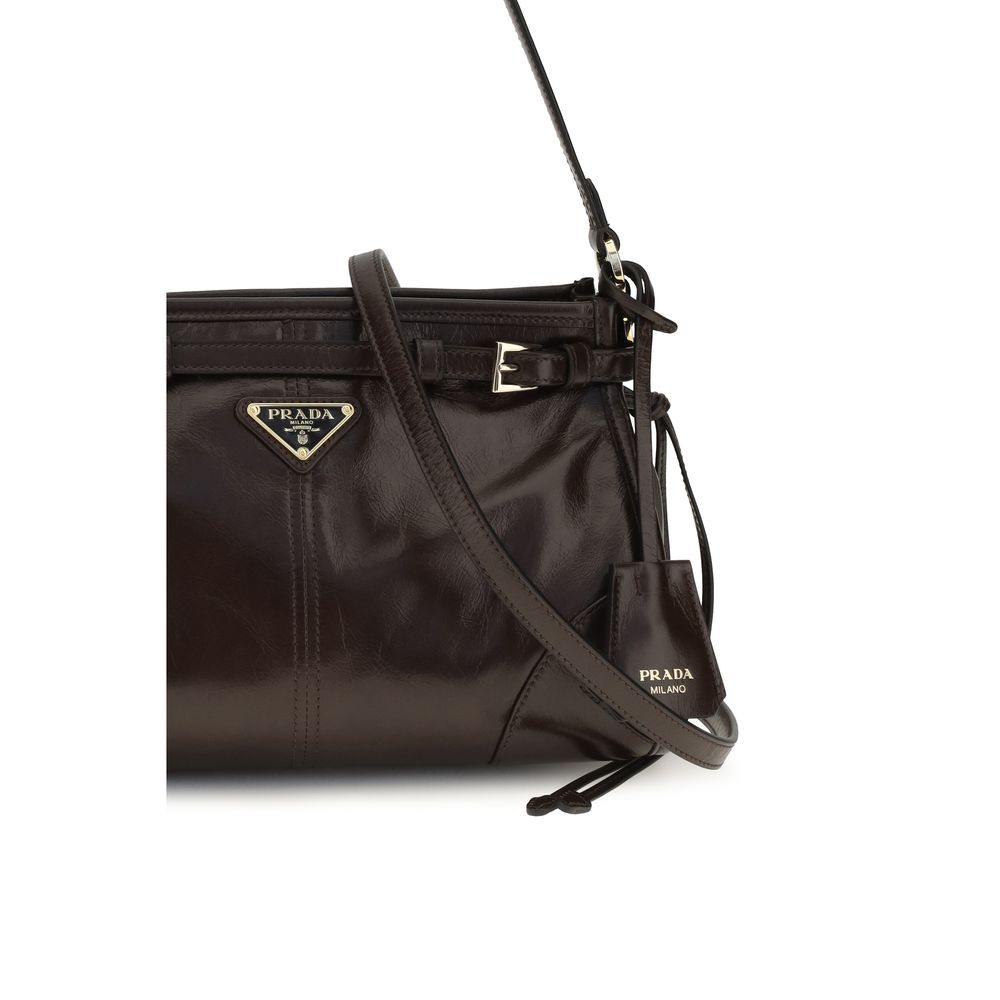 This Mini Hobo Handbag by Prada for women in polyurethane nylon & bos taurus calf leather and brown & signature presents a sculptural silhouette featuring a secure zipper, ample , and versatile shoulder-strap, handle, adjustable-strap, detachable-strap & belt-strap for a sculptural finish.