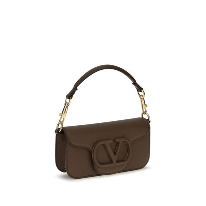 Mini 2-in-1 Shoulder & Crossbody Bag by Valentino Garavani for women in bos taurus calfskin leather brown, gold & signature presents a versatile silhouette, showcasing a secure magnetic and versatile with versatile crossbody-strap, shoulder-strap, detachable-strap & handle for a sophisticated look.