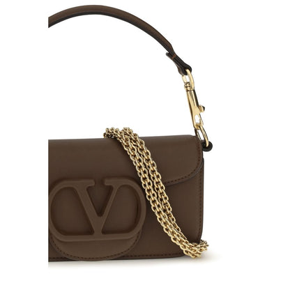 Mini 2-in-1 Shoulder & Crossbody Bag by Valentino Garavani for women in bos taurus calfskin leather brown, gold & signature presents a versatile silhouette, showcasing a secure magnetic and versatile with versatile crossbody-strap, shoulder-strap, detachable-strap & handle for a sophisticated look.