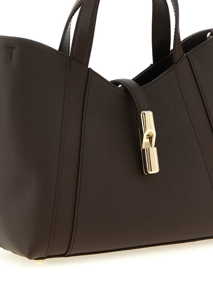 Tote Bag by Furla for women in calfskin leather brown & gold features a jet-set Goccia Calfskin Leather Tote Bag design, complete with a secure , ample , and versatile handle & adjustable-strap for a jet-set look.