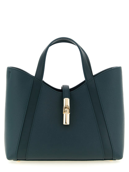 Tote Bag by Furla for women in calfskin leather & cotton bicolour, gold, green & teal features an jet-setting Goccia Calfskin Leather & Cotton Tote Bag design with a secure zipper, jet-setting , and versatile handle & adjustable-strap for a jet-setting look.