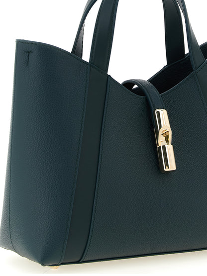 Tote Bag by Furla for women in calfskin leather & cotton bicolour, gold, green & teal features a jet-set sophisticated Goccia Calfskin Leather & Cotton Tote Bag design with a secure zipper, ample , and versatile handle & adjustable-strap for a jet-set sophisticated finish.
