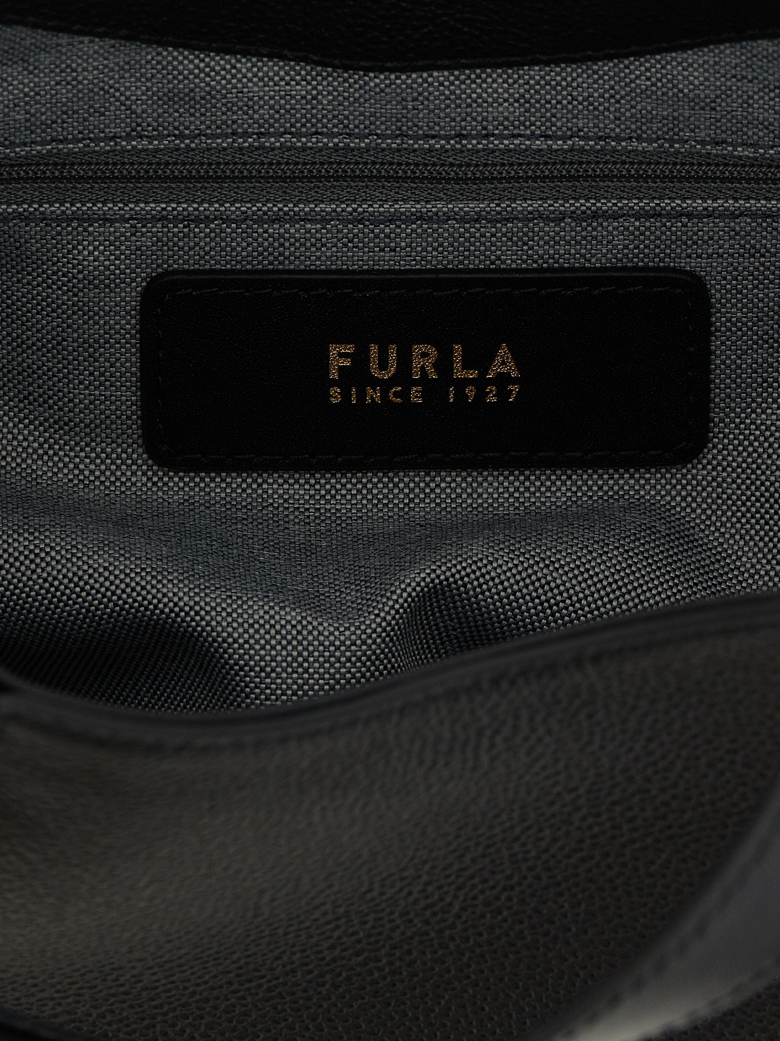 Tote Bag by Furla for women in calfskin leather black & gold features a jet-set Goccia Calfskin Leather Tote Bag design, complete with a secure , ample , and versatile shoulder-strap, handle & adjustable-strap for a jet-set look.