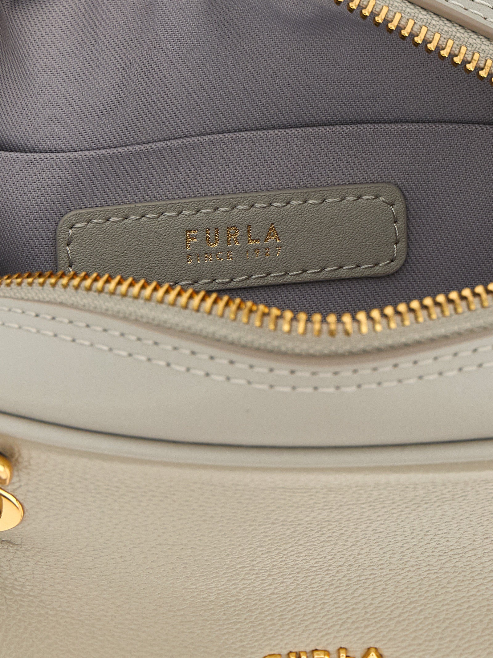 Dome Handbag by Furla for women in calfskin leather gray & gold features an refined silhouette, showcasing a secure zipper, ample , and versatile shoulder-strap, detachable-strap & handle for a sophisticated refined aesthetic.