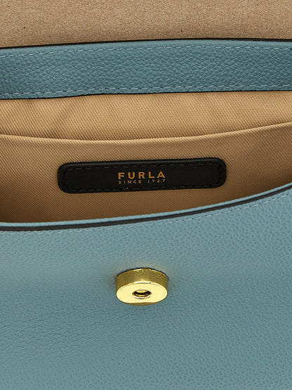 This Compact Flap Handbag by Furla for women in calfskin leather and gold & light-blue presents a sculptural silhouette featuring a secure flap & magnetic, ample , and versatile handle for a sculptural finish.