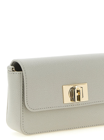 Mini Crossbody Flap Handbag by Furla for women in calfskin leather gray features a transformative sophistication silhouette, showcasing a secure flap & turn-lock, ample , and versatile crossbody-strap for a transformative sophistication look.