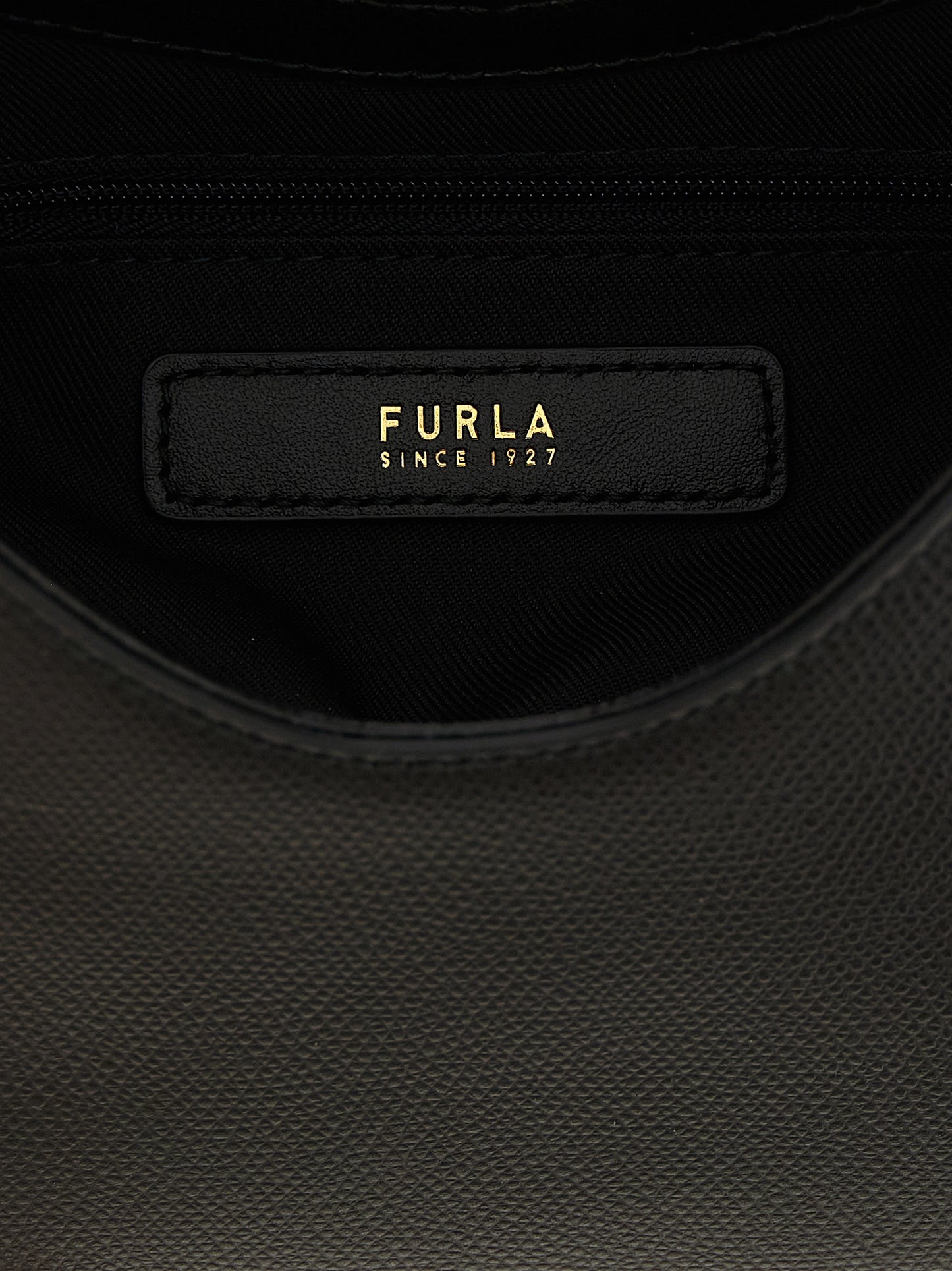 Mini Handbag by Furla for women in calfskin leather & cotton black & gold features a ornamental silhouette, showcasing a secure zipper & clasp, ample , and ornamental shoulder-strap, handle & adjustable-strap for a sophisticated look.