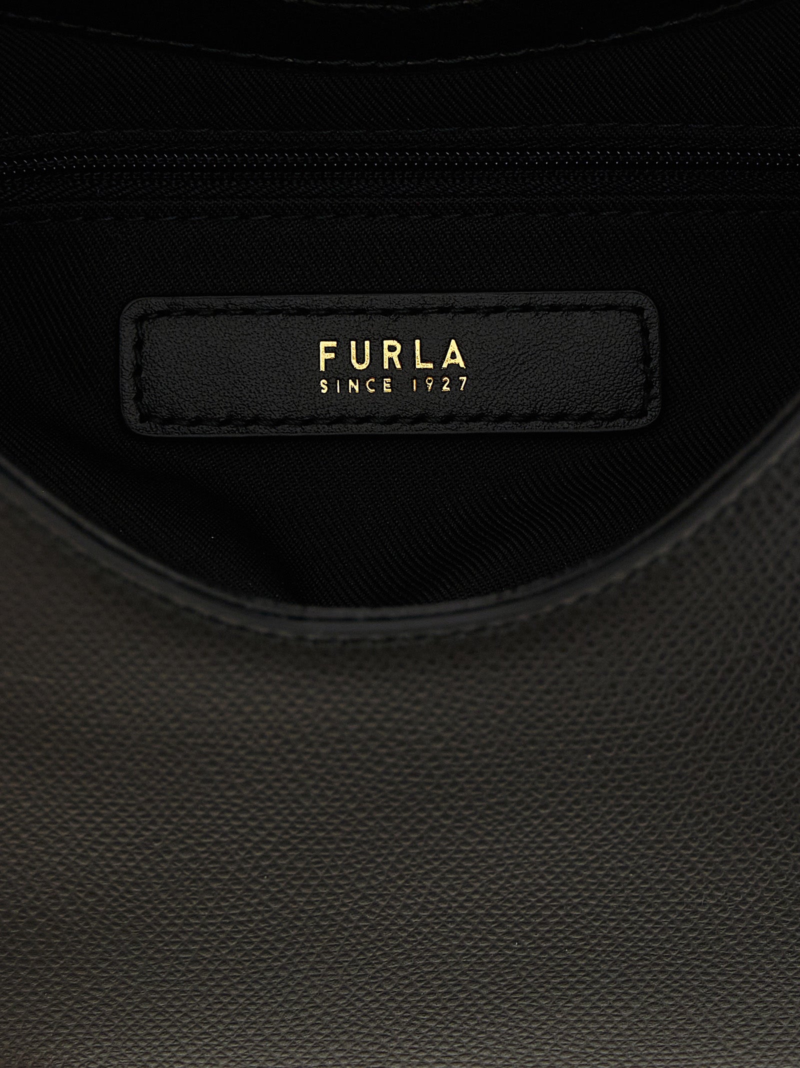 Mini Handbag by Furla for women in calfskin leather & cotton black & gold features a ornamental silhouette, showcasing a secure zipper & clasp, ample , and ornamental shoulder-strap, handle & adjustable-strap for a sophisticated look.