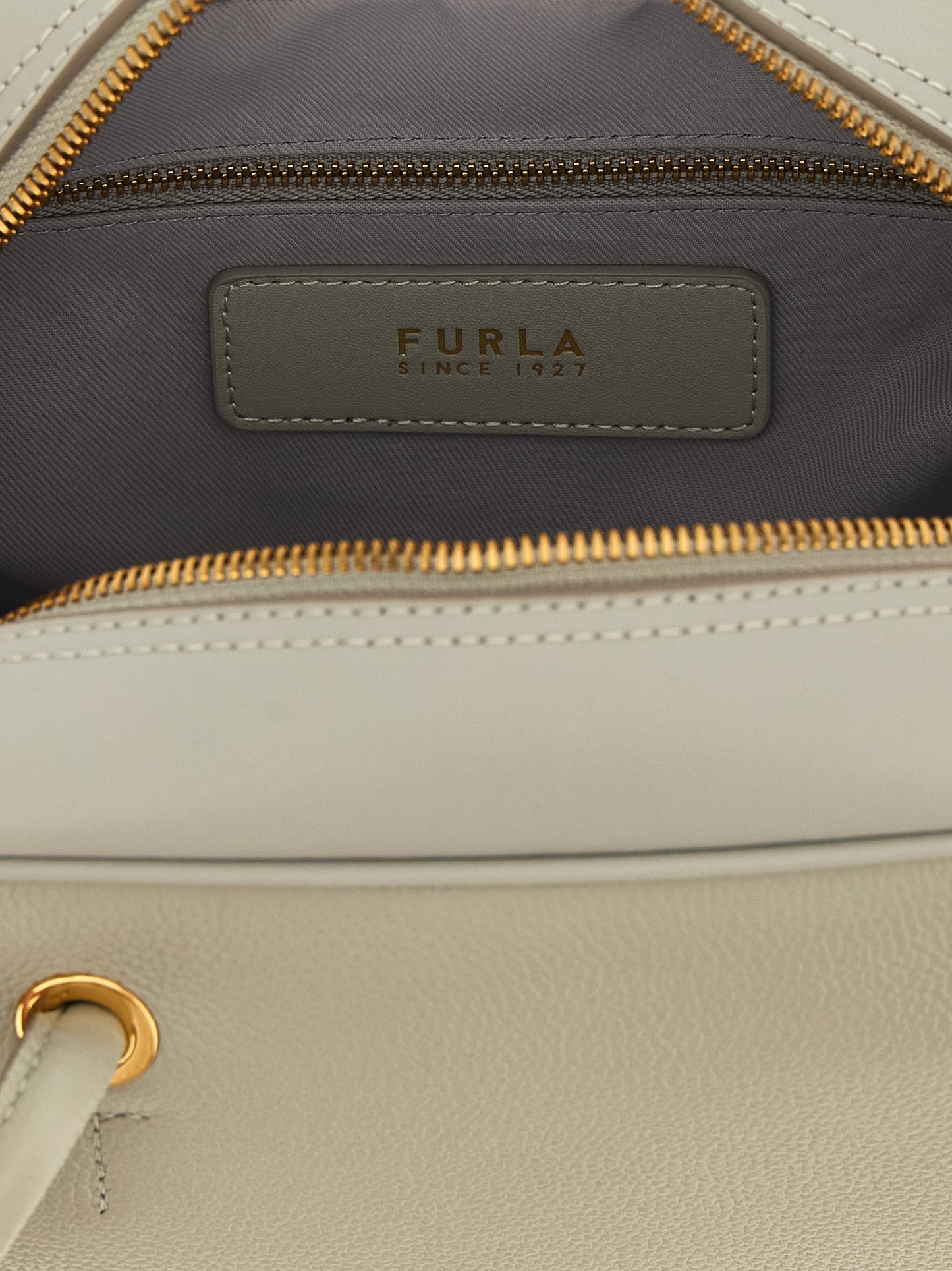 This Dome Handbag by Furla for women in calfskin leather and gray & gold presents a sculptural silhouette featuring a secure , ample , and versatile adjustable-strap & handle for a sculptural finish.