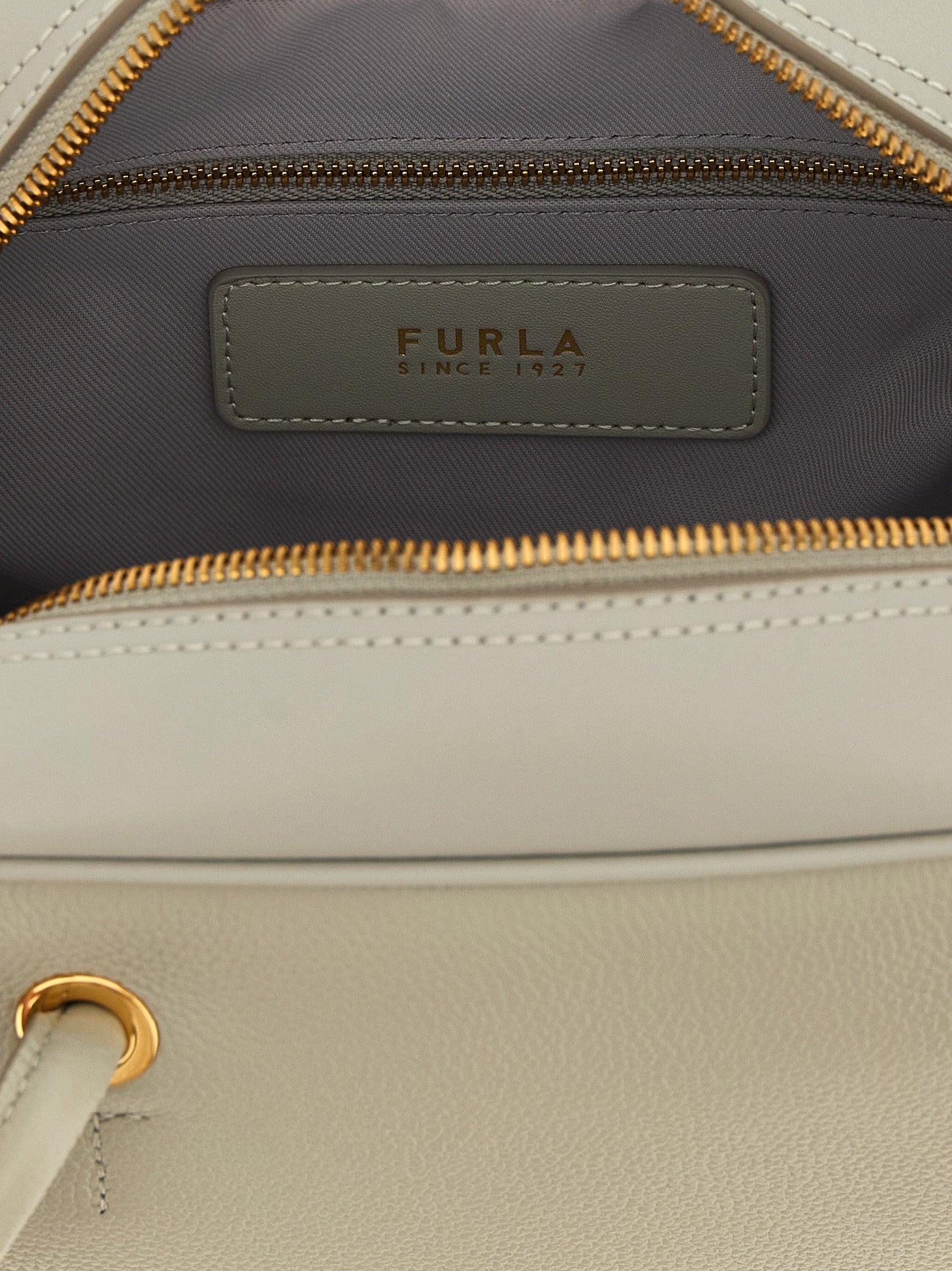 This Dome Handbag by Furla for women in calfskin leather and gray & gold presents a sculptural silhouette featuring a secure , ample , and versatile adjustable-strap & handle for a sculptural finish.