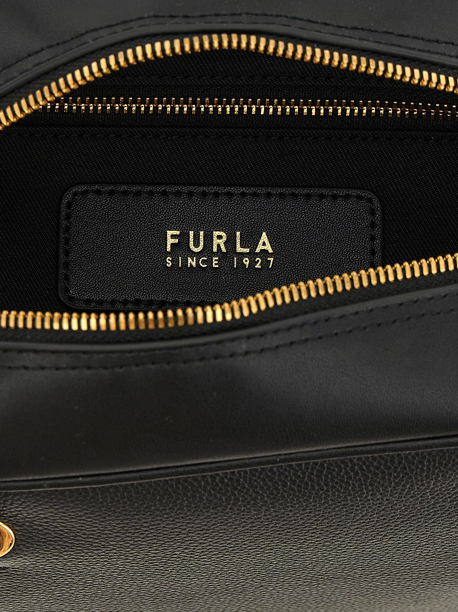 This Dome Handbag by Furla for women in calfskin leather and black & gold presents a sculptural silhouette featuring a secure zipper, ample , and versatile handle for a sculptural finish.