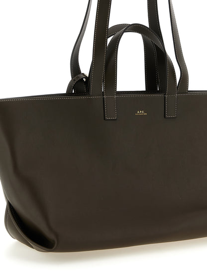 Tote Clutch Bag by A.P.C. for women in leather & cotton brown & gold showcases a statuesque Le Drummer Leather & Cotton Tote Clutch Bag design, featuring a secure , ample , and versatile handle for a statuesque finish.