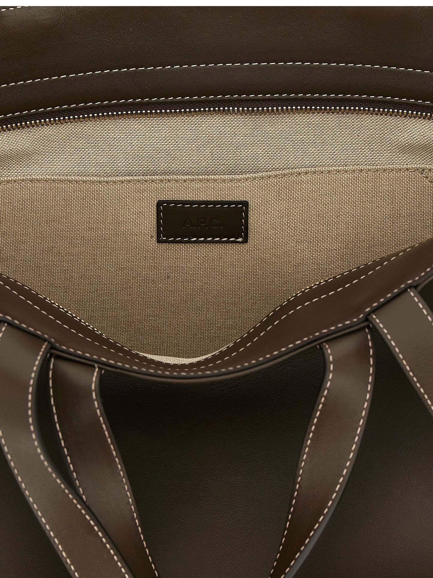 This Tote Clutch Bag by A.P.C. for women in leather & cotton brown & gold features an jet-set Le Drummer Leather & Cotton Tote Clutch Bag design with a secure , ample , and jet-set handle.