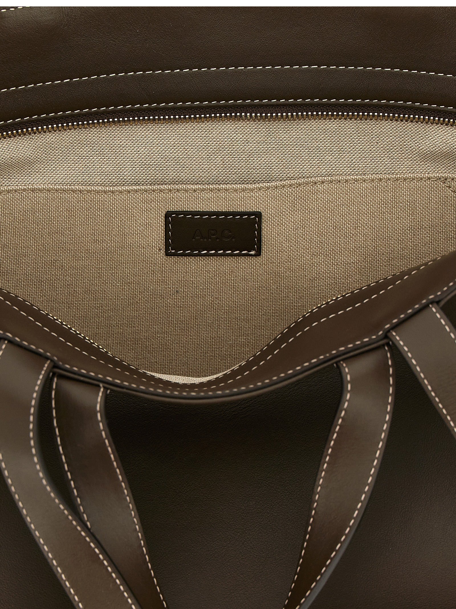 This Tote Clutch Bag by A.P.C. for women in leather & cotton brown & gold features an jet-set Le Drummer Leather & Cotton Tote Clutch Bag design with a secure , ample , and jet-set handle.