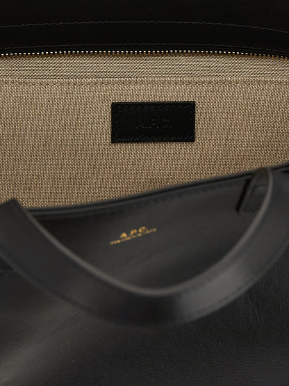 Small Shopper Tote Clutch Bag by A.P.C. for women in cotton polyester canvas black & gold features an jet-set-ready silhouette, showcasing the Le Drummer Cotton Polyester Canvas Small Shopper Tote Clutch Bag design with a secure zipper, ample , and versatile handle.