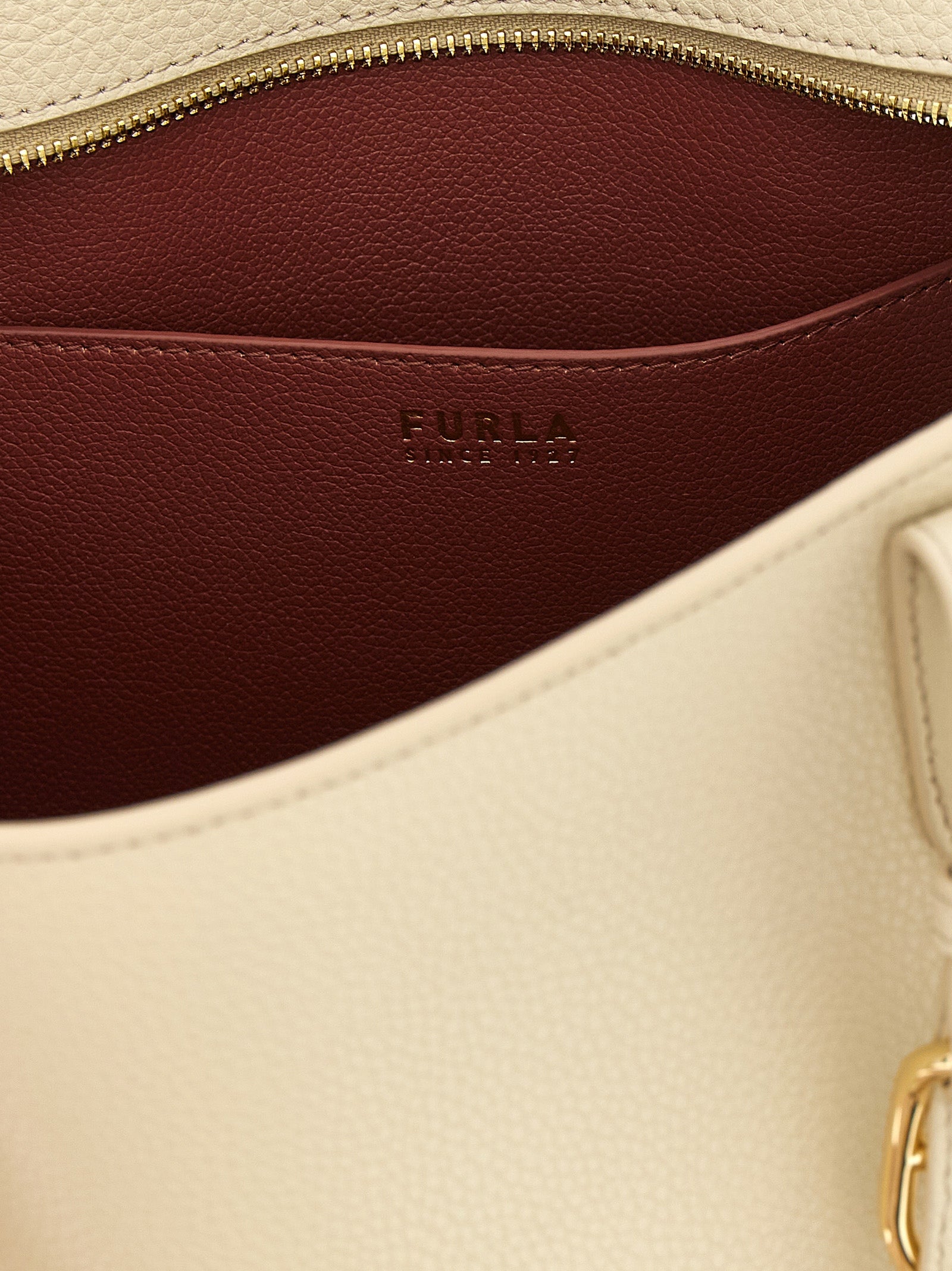 Pouch Tote Bag by Furla for women in calfskin leather burgundy, cream, gold & white showcases a statuesque 1927 Ava Calfskin Leather Pouch Tote Bag design, featuring a secure zipper & buckle, ample , and versatile handle & adjustable-strap for a statuesque finish.