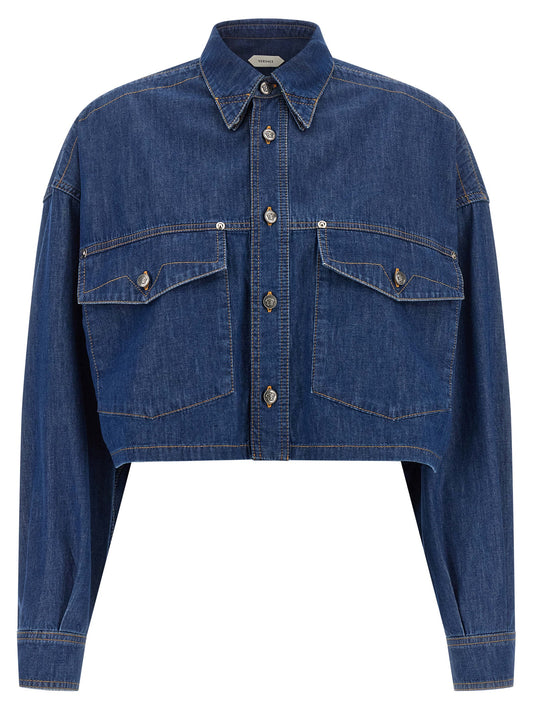 Blouse by Versace for women in denim cotton blue & silver showcases a sleek silhouette, elegantly detailed with a sleek square neckline and for a sleek finish.