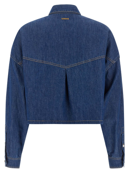 Blouse by Versace for women in denim cotton blue & silver showcases a sharp silhouette, elegantly detailed with a sharp square neckline and sharp .