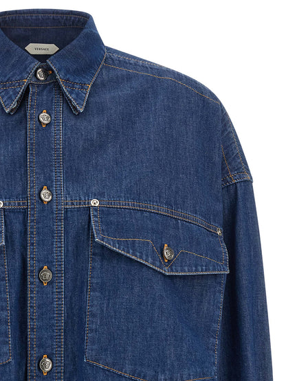 Blouse by Versace for women in denim cotton blue & silver showcases a sublime silhouette, artfully detailed with a sublime square neckline and for a sophisticated, sublime finish.