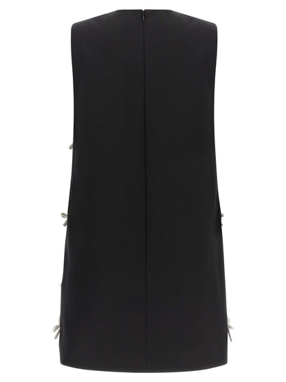 Dress by Moschino for women in virgin wool bicolour & patterned features a dramatic silhouette, showcasing an elegant round neckline and that flows into a dramatic short mini.