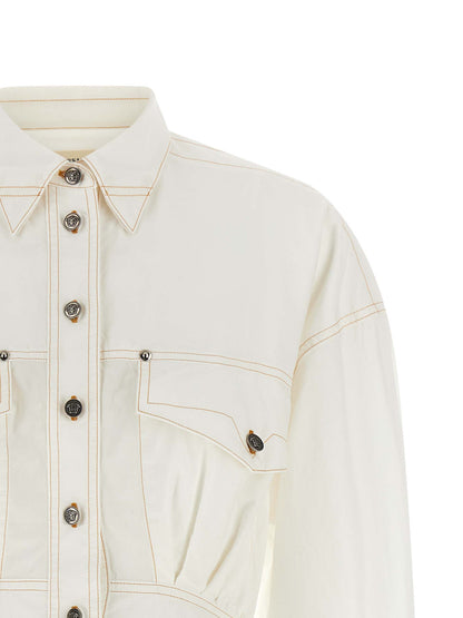 Dress by Versace for women in cotton white showcases a striking silhouette, elegantly detailed with a , refined , and a striking short for a striking finish.