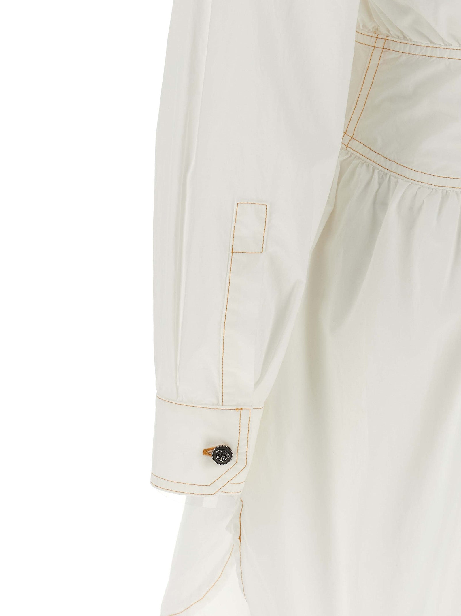 Dress by Versace for women in cotton white presents a sinuous silhouette, showcasing a sophisticated and detailed with a sinuous short for a refined finish.