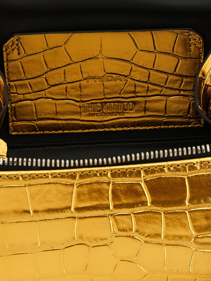 This Mini Handbag by The Attico for women in crocodile skin leather and gold, silver & print presents a sculptural silhouette featuring a secure zipper, ample , and versatile shoulder-strap, handle, adjustable-strap & detachable-strap for a sculptural finish.