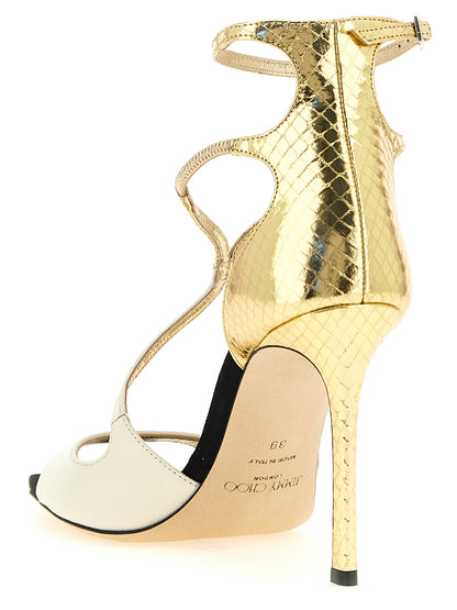 Stiletto Ankle Strap Sandals by Jimmy Choo for women in leather & metal cream, gold, multicolor & print features an statuesque Women's Leather & Metal Stiletto Ankle Strap Sandals silhouette with a refined stiletto and elegant square toe style.