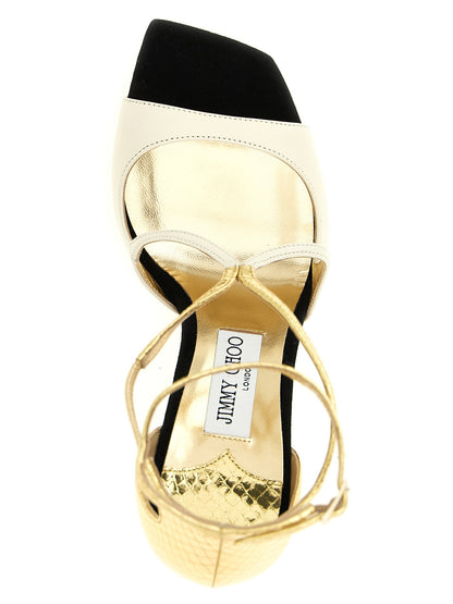 Stiletto Ankle Strap Sandals by Jimmy Choo for women in leather & metal cream, gold, multicolor & print features an exquisite silhouette, showcasing the exquisite Women's Leather & Metal Stiletto Ankle Strap Sandals with a stiletto and square toe style.