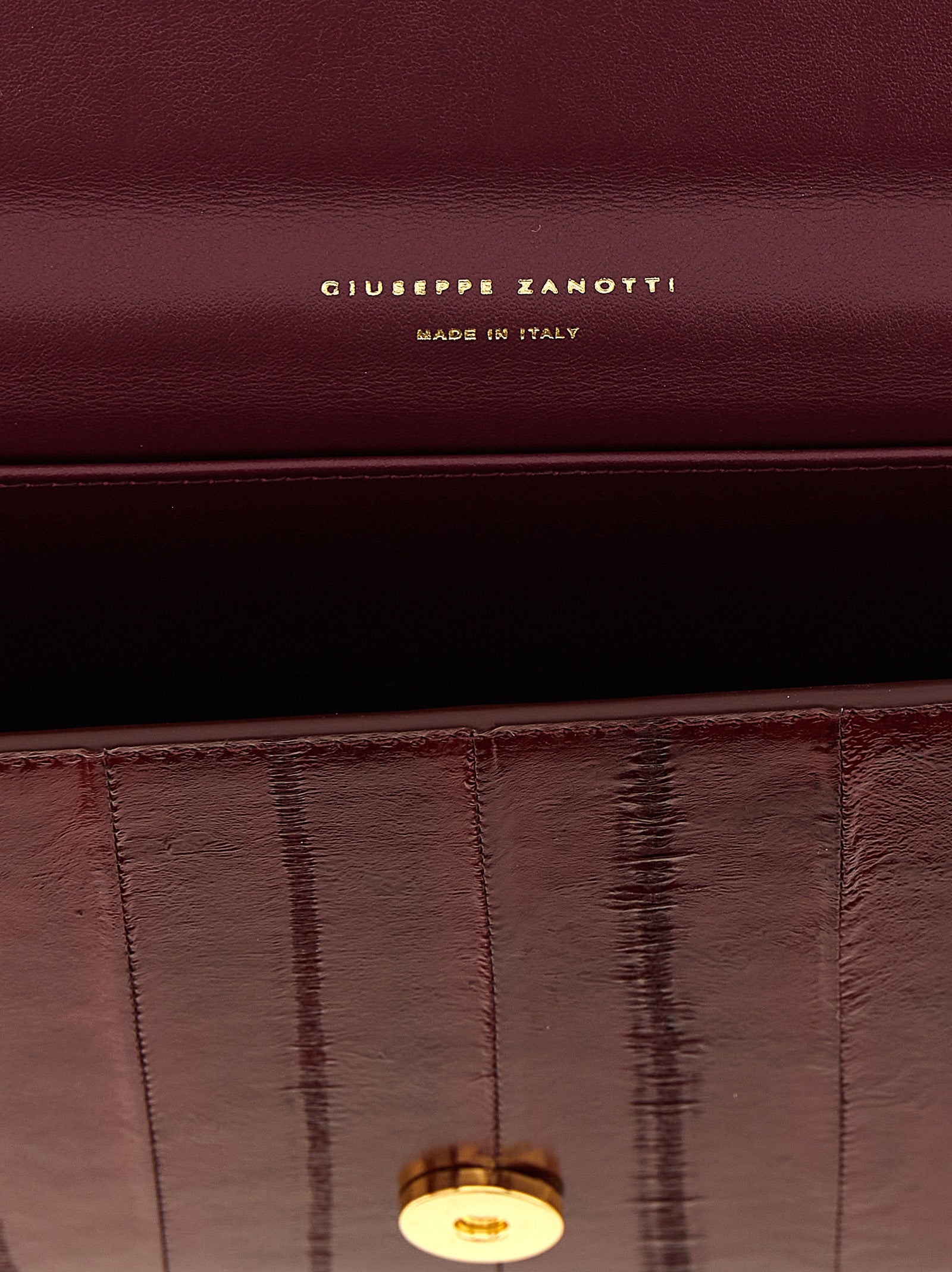 Evening Envelope Clutch Handbag by Giuseppe Zanotti for women in polyamide bordeaux, burgundy & gold showcases a sculptural silhouette, featuring a secure flap, magnetic & button, ample , and versatile shoulder-strap & detachable-strap for a sculptural finish.