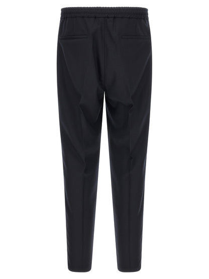 Trousers by Brunello Cucinelli for men in virgin wool & flannel navy features an on trend silhouette, showcasing a sophisticated tapered-leg & relaxed-fit with a long and for an on trend finish.