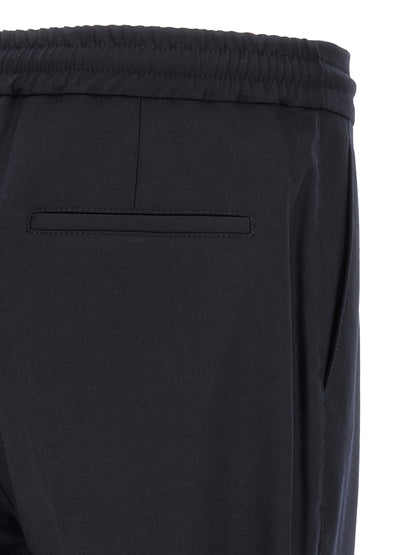 Trousers by Brunello Cucinelli for men in virgin wool & flannel navy features an on trend silhouette, showcasing a sophisticated tapered-leg & relaxed-fit with a long and for an on trend finish.