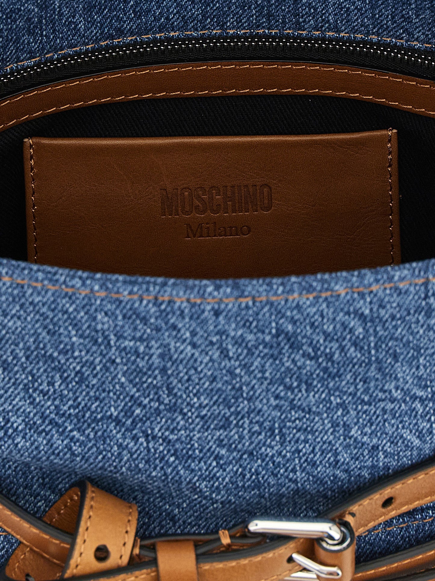 Flap Handbag by Moschino for women in calf leather & cotton blue & silver presents a ornamental silhouette, showcasing a secure flap, zipper & buckle, ample , and versatile shoulder-strap, handle, adjustable-strap, detachable-strap & belt-strap for a ornamental finish.