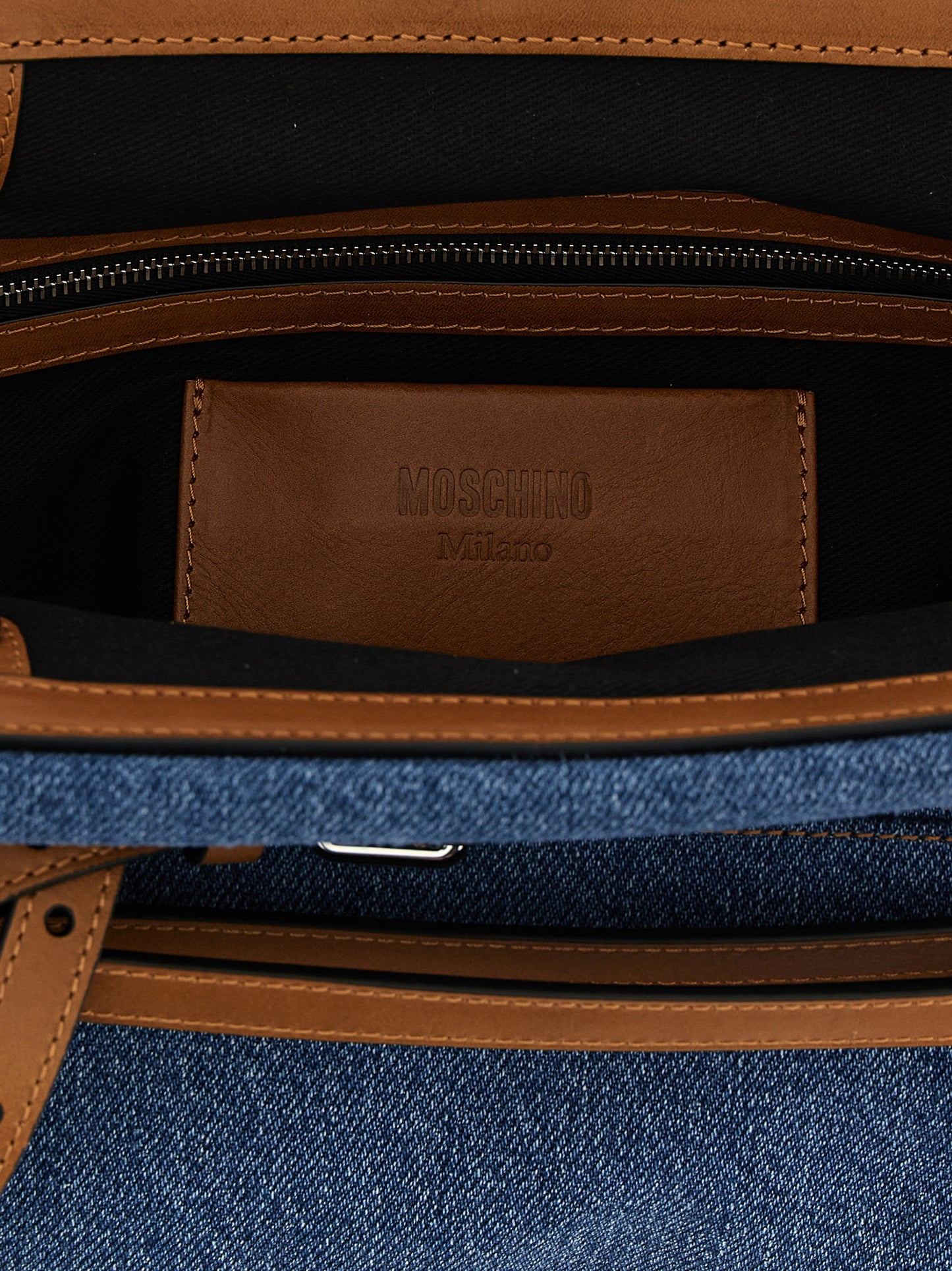 Large Clutch Handbag by Moschino for women in calf leather & cotton blue & silver showcases a sculptural silhouette, featuring a secure zipper, magnetic & buckle, ample internal-pockets, and versatile shoulder-strap, adjustable-strap, detachable-strap & belt-strap for a sculptural finish.