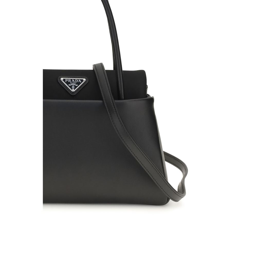 Compact Handbag by Prada for women in bos taurus calfskin leather black & signature features a refined silhouette, showcasing a secure , organized , and versatile shoulder-strap, handle & detachable-strap for a refined finish.