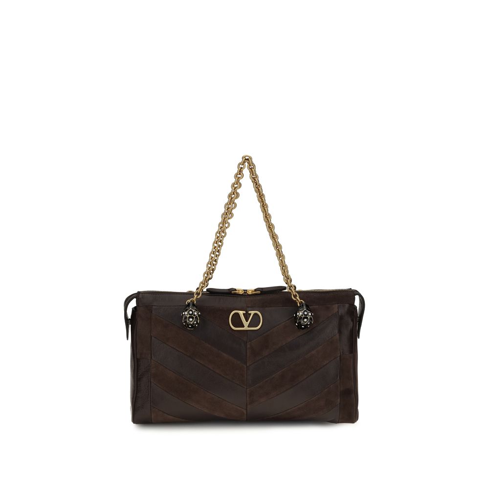 Medium Shoulder Bag by Valentino Garavani for women in bio-acetate & bos taurus calf leather brown, gold, chevron, signature & patchwork features a effortless chic silhouette with a secure zipper, ample single-compartment, and versatile shoulder-strap, adjustable-strap & handle for a effortless chic finish.