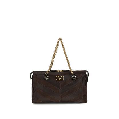 Medium Shoulder Bag by Valentino Garavani for women in bio-acetate & bos taurus calf leather brown, gold, chevron, signature & patchwork features a effortless chic silhouette with a secure zipper, ample single-compartment, and versatile shoulder-strap, adjustable-strap & handle for a effortless chic finish.