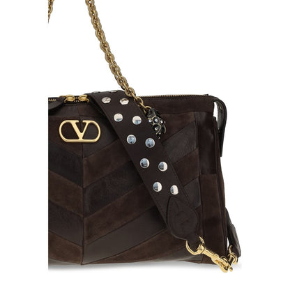 Medium Shoulder Bag by Valentino Garavani for women in bio-acetate & bos taurus calf leather brown, gold, chevron, signature & patchwork features a distinguished silhouette, showcasing a secure zipper and distinguished single-compartment with versatile shoulder-strap, adjustable-strap & handle for a distinguished finish.