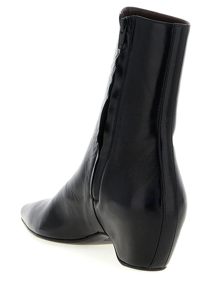 Wedge Ankle Boots by Khaite for women in calfskin leather black features an avant-garde Women's Calfskin Leather Wedge Ankle Boots silhouette, defined by a sophisticated wedge and a avant-garde pointed toe style.